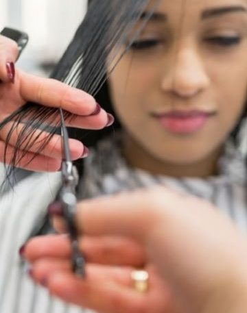 woman is getting curtain bang cut at beverly hills salon