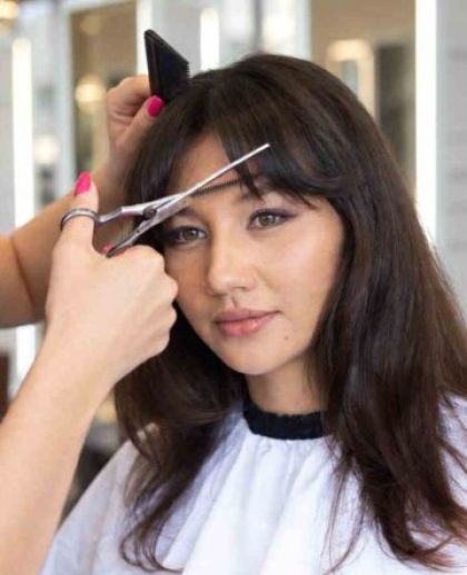 woman is getting bang cut and style in Los Angeles