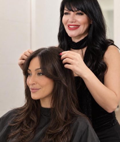 Woman with curtain bangs and long hair at Gloss & Glam