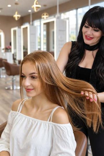 Stylist applying a hair botox treatment to a client at a Los Angeles salon